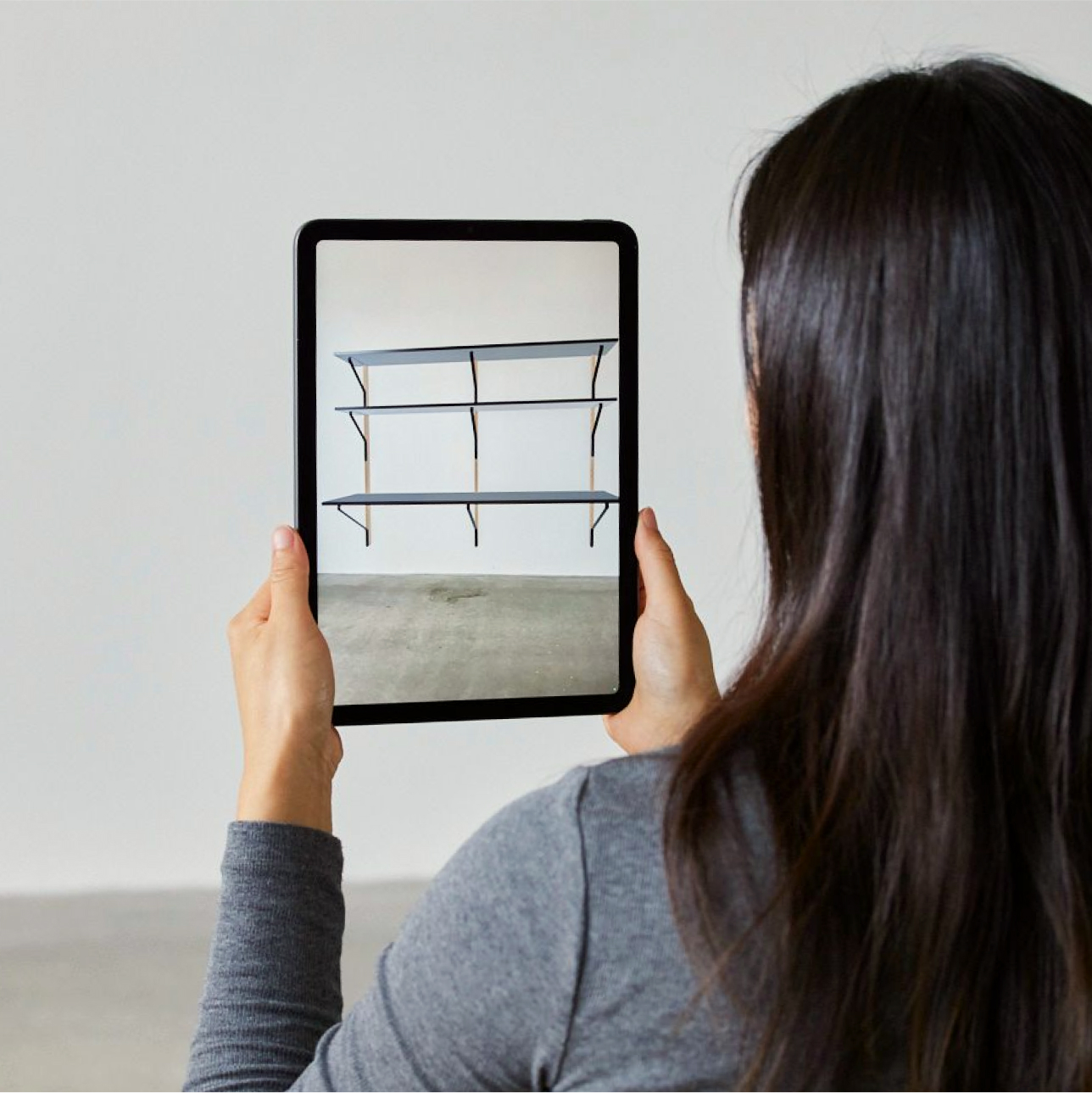 Person interacting with 3D visualization of shelves on a tablet device